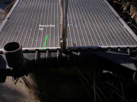 1997 Ford Taurus - Radiator part shown with a green line and text indicating where to bend a tab.