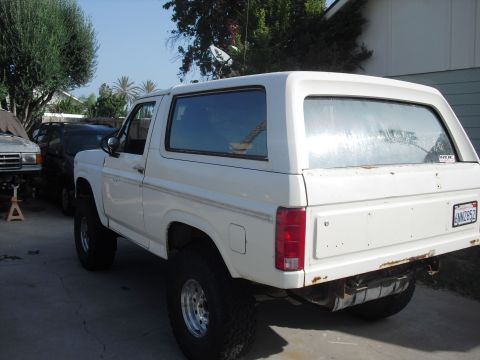 1986 Ford Bronco - This 1986 Ford Bronco features a lifted suspension and off-road tires, giving it a appearance.