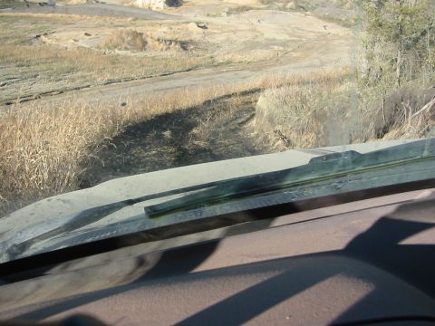 1991 Ford Bronco - Looking out from the interior of a vehicle at a dry, outdoor landscape.