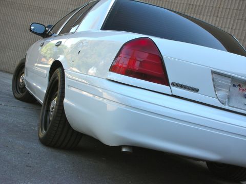 2004 Ford Crown Victoria - Rear view of a 2004 Ford Crown Victoria, highlighting the "POLICE INTERCEPTOR" badging.