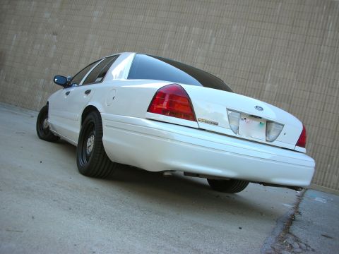 2004 Ford Crown Victoria - Rear view of a white 2004 Ford Crown Victoria, black wheels and a clean body.