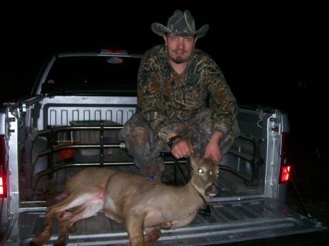 2010 Champion 188 - Hunter displays his catch in the back of a pickup truck after a night hunt.