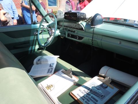 1979 Chevrolet Camaro - The interior of a classic car features a dashboard with a radio and a steering wheel, along with documents on the seats.