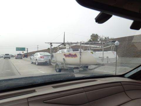 1993 Ford Taurus - Silver sedan towing a boat trailer with 'Toon Town' graphic on the highway.