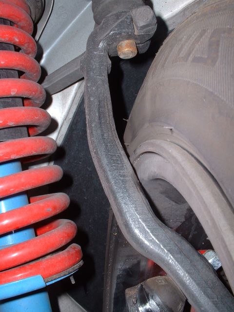 1997 Mercury Cougar - Suspension linkage and coil spring are visible near the tire.