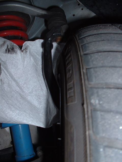 1997 Mercury Cougar - Close-up view of a car's suspension system, including a tire and shock absorber.