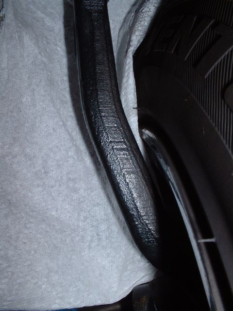 1997 Mercury Cougar - Close-up view of a black suspension part and a tire, with "SUPERMOTORS.NET" visible at the bottom.