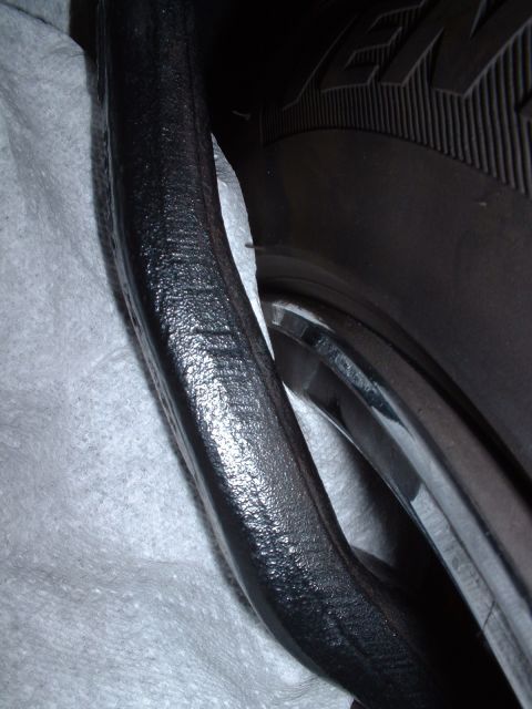 1997 Mercury Cougar - A suspension part is shown next to a tire and rim.