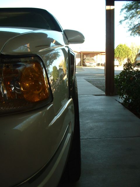 1997 Mercury Cougar - Close-up side view of a 1997 Mercury Cougar's front fender and headlight assembly.
