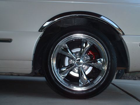 1997 Mercury Cougar - A custom chrome wheel with red brake calipers is shown on the side of a vehicle.