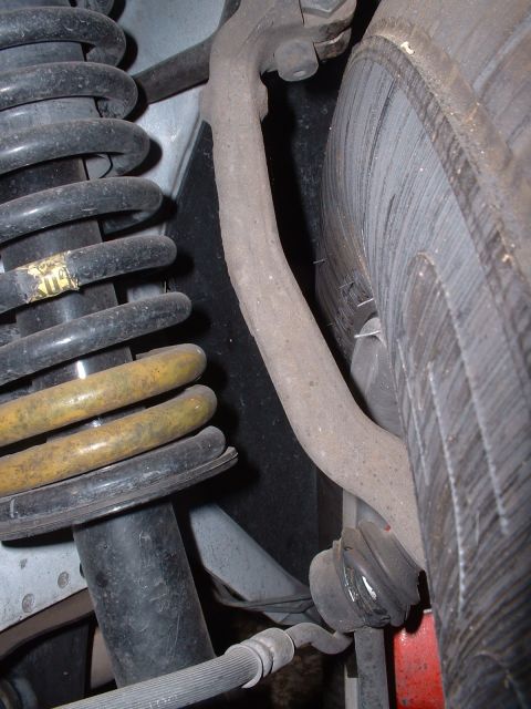 1997 Mercury Cougar - Close-up view of a vehicle's suspension system, showing springs, a shock absorber, and a control arm.