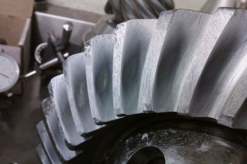 1999 Chevrolet Camaro - Differential gear set showing wear on teeth. A dial indicator is visible in the background.