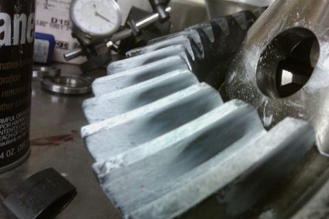 1999 Chevrolet Camaro - Gears are shown with a dial indicator and a can of spray in this close-up workshop scene.