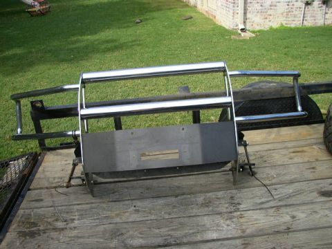 1995 Ford Bronco - A chrome winch bumper with a brush guard is shown mounted on a trailer.