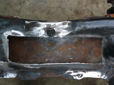 1976 Chevrolet Corvette - A section of a car's frame, showing signs of repair and rust, is presented for identification.