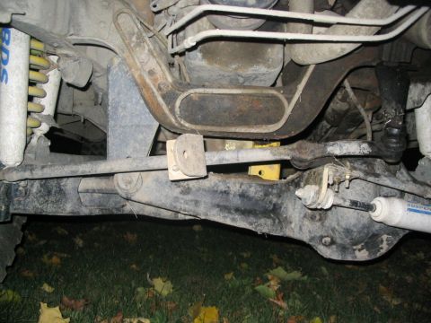 1986 Ford Bronco - Close-up view of the vehicle's suspension and drivetrain components, showing aftermarket modifications.