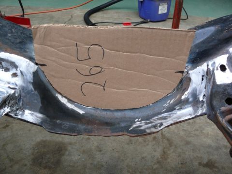 1976 Chevrolet Corvette - A cardboard template labeled '265' is positioned over a section of a car's frame.