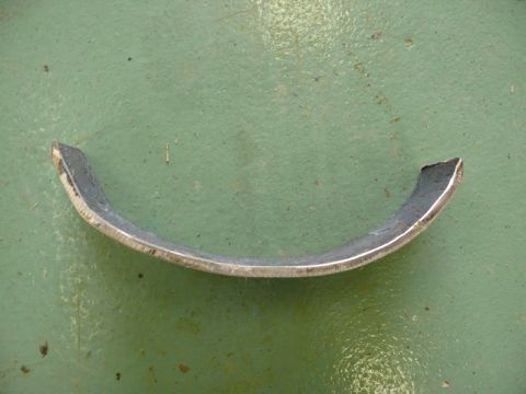 1976 Chevrolet Corvette - A single curved metal bracket is shown against a green background.