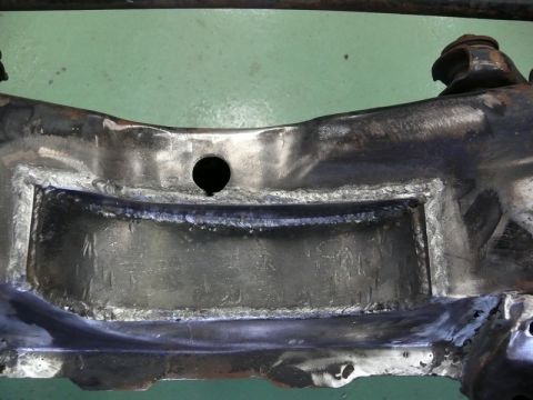 1976 Chevrolet Corvette - This image shows a close-up view of a metal frame component that has undergone welding work.