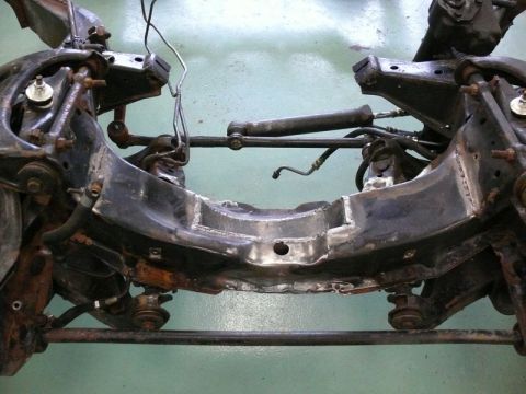 1976 Chevrolet Corvette - Front suspension subframe assembly with steering components attached.