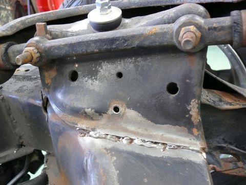 1976 Chevrolet Corvette - This image shows a close-up view of a vehicle's rusty suspension system and chassis components.