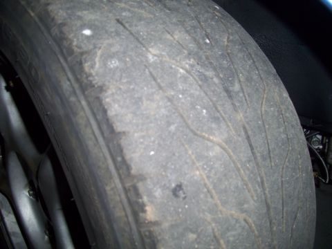 1995 Ford Probe - Close-up of a heavily worn tire, showing the tread pattern and signs of extensive use.