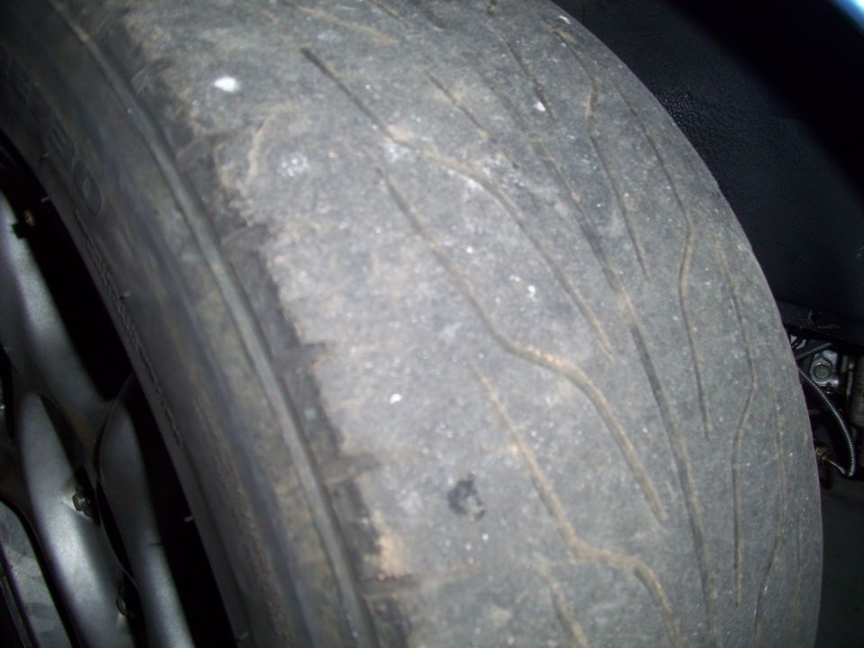 Worn tire tread with visible wear indicators and some debris