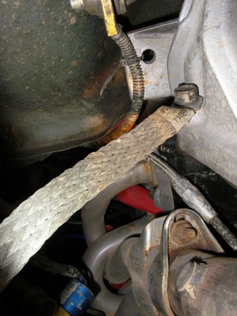 1990 Ford Bronco - Undercarriage view shows wiring harness and exhaust components.