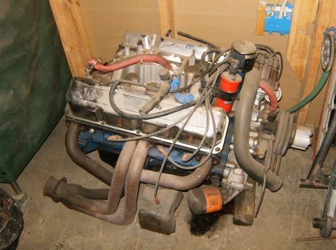 2000 Ford E350 - A V8 engine with custom headers and an oil filter is shown indoors, possibly in a garage or workshop.