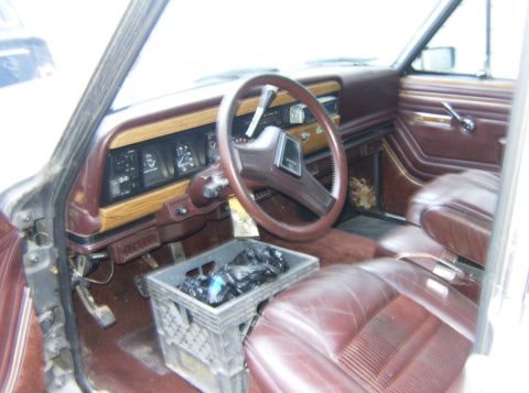 2000 Ford E350 - The interior of a Jeep Grand Wagoneer shows its classic dashboard and seating.