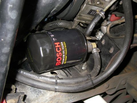 1990 Ford Bronco - The photo shows a Bosch oil filter and associated transmission lines, not a 1990 Ford Bronco.