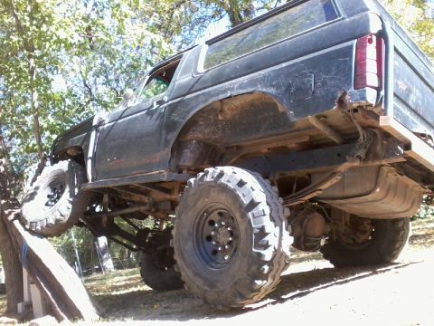 1986 Ford Bronco - This heavily modified Ford Bronco is shown off-roading on a wooden ramp.