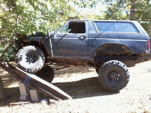1986 Ford Bronco - This modified SUV is positioned on an obstacle course, its off-road capabilities.