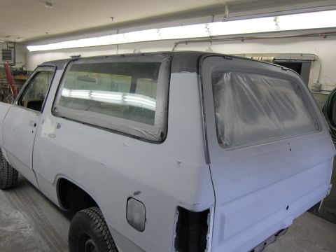 1987 Dodge 1500 - The rear of a white pickup truck body, prepared for painting, is shown from a 3/4 rear angle.