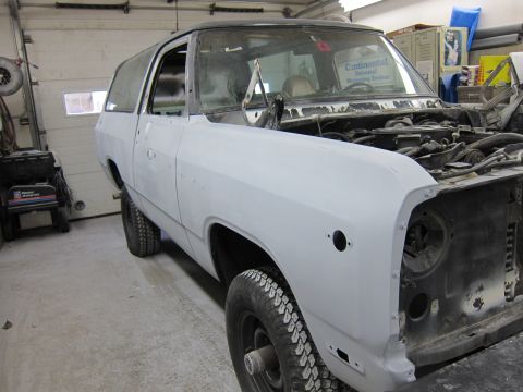 1987 Dodge 1500 - A Dodge Ramcharger SUV is shown in a garage, prepped for paint with its hood open.