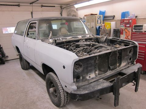 1987 Dodge 1500 - This SUV is in a garage with its hood open, showing the engine compartment and front end.