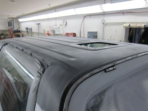 1987 Dodge 1500 - The vehicle's roof is prepped for paint, showing a sunroof and taped-off windows.