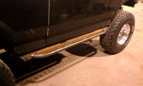 1979 Ford Bronco - This vehicle features custom running boards made of metal and wood, paired with off-road tires.