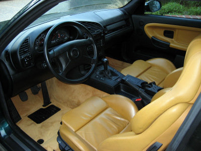 1998 BMW M3 - Interior view of a 1998 BMW M3, showing tan leather seats and dashboard details.