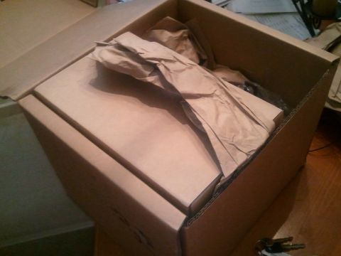 1994 Ford Bronco - A cardboard box containing packing paper is shown from above.