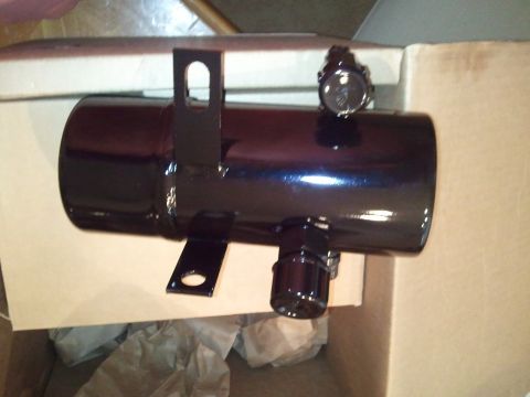 1994 Ford Bronco - Black metal canister with gauge and mounting brackets, likely an aftermarket automotive part.