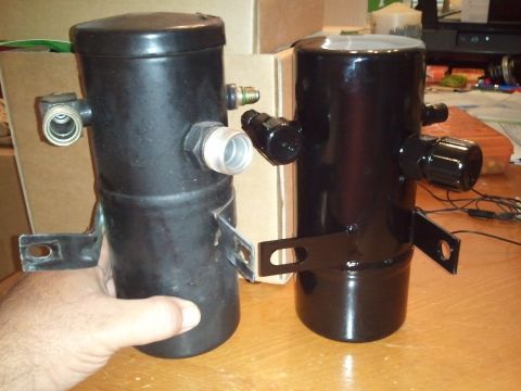 1994 Ford Bronco - Two black AC receiver-driers are shown, one appearing older and the other recently painted.