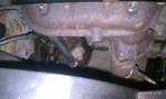 1994 Ford Probe - Close-up view of a rusty exhaust manifold, part of a vehicle's engine system.