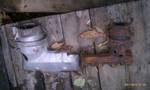 1994 Ford Probe - Two old exhaust pipe sections are shown resting on a wooden surface.