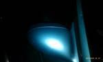 1994 Ford Probe - A bright blue light emanates from a vehicle's headlight assembly in this close-up shot.