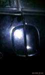 1994 Ford Probe - Close-up of a black door handle with chrome trim, likely a car part.