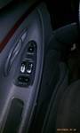 1994 Ford Probe - Close-up of a car's interior door panel, showing the window and lock controls.