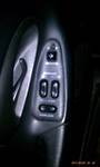 1994 Ford Probe - Close-up of the interior door panel, highlighting the power window controls.