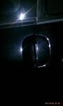 1994 Ford Probe - A close-up shot of a vehicle's side mirror at night, with light reflecting off its surface.