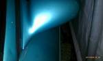 1994 Ford Probe - Abstract blue light reflects off a curved metallic surface, suggesting a vehicle component.